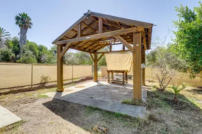 a wooden gazebo with a chair under it at Pet-Friendly Apt 11 Mi to Dtwn San Diego! in Spring Valley