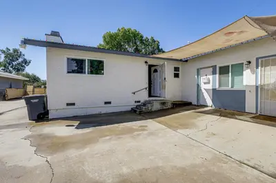 a white house with a driveway in front of it at Pet-Friendly Apt 11 Mi to Dtwn San Diego! in Spring Valley