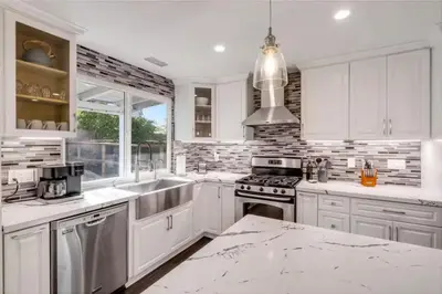 a white kitchen with a sink and a stove at HUGE 5BR Family Retreat Backyard & Patio Lounge in Santee