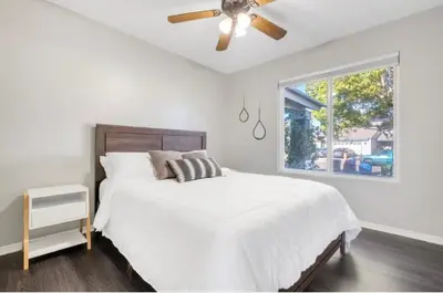 a white bedroom with a bed and a ceiling fan at HUGE 5BR Family Retreat Backyard & Patio Lounge in Santee