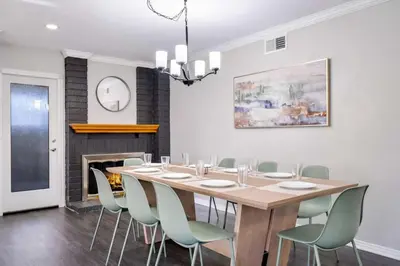 a dining room with a table and chairs and a fireplace at HUGE 5BR Family Retreat Backyard & Patio Lounge in Santee