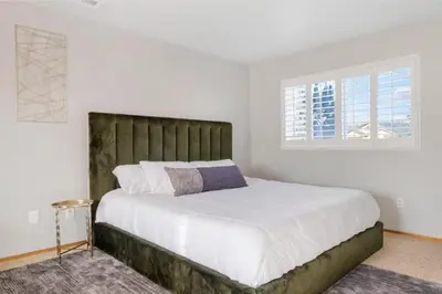 a bedroom with a large bed with white sheets and a window at HUGE 5BR Family Retreat Backyard & Patio Lounge in Santee
