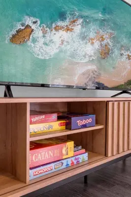 a tv sitting on top of a shelf with books at HUGE 5BR Family Retreat Backyard & Patio Lounge in Santee