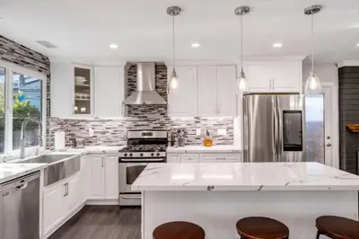 a kitchen with white cabinets and stainless steel appliances at HUGE 5BR Family Retreat Backyard & Patio Lounge in Santee