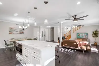 a kitchen and living room with a ceiling fan at HUGE 5BR Family Retreat Backyard & Patio Lounge in Santee