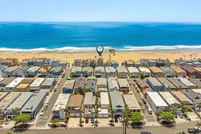 an aerial view of a parking lot next to the beach at Luxury 4Br Beachfront Home W Panoramic Ocean Views By Beachview Rentals in Newport Beach
