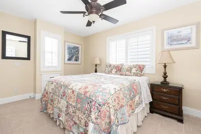 a bedroom with a bed and a ceiling fan at Luxury 4Br Beachfront Home W Panoramic Ocean Views By Beachview Rentals in Newport Beach