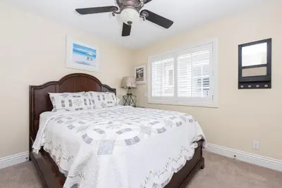 a bedroom with a bed and a ceiling fan at Luxury 4Br Beachfront Home W Panoramic Ocean Views By Beachview Rentals in Newport Beach
