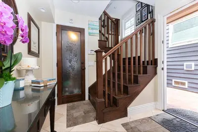 aoyer with a wooden staircase and a wooden door at Luxury 4Br Beachfront Home W Panoramic Ocean Views By Beachview Rentals in Newport Beach