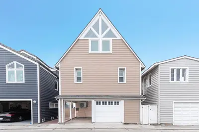 a large house with a gambrel roof and a garage at Luxury 4Br Beachfront Home W Panoramic Ocean Views By Beachview Rentals in Newport Beach