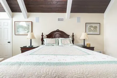 a bedroom with a large bed with two lamps at Luxury 4Br Beachfront Home W Panoramic Ocean Views By Beachview Rentals in Newport Beach