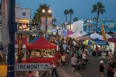 a crowd of people walking around a market with tents at Retro Star-Wagon, Ocean Breez at Studios in Oceanside