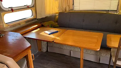 a table in a train with a book on it at Retro Star-Wagon, Ocean Breez at Studios in Oceanside