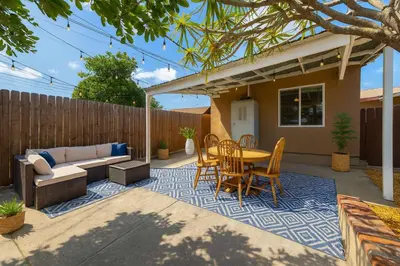 a patio with a couch and a table and chairs at Cozy Pet Friendly Escape with Outdoor Dining in San Diego