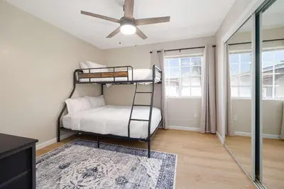 a bedroom with a bunk bed and a ceiling fan at Cozy Pet Friendly Escape with Outdoor Dining in San Diego