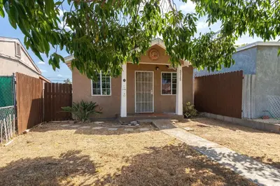 a house with a fence and a gate at Cozy Pet Friendly Escape with Outdoor Dining in San Diego
