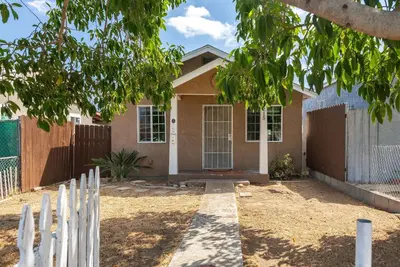 a house with a white fence in front of it at Cozy Pet Friendly Escape with Outdoor Dining in San Diego