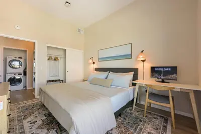 a bedroom with a bed and a desk with a computer at Luxury Living in N Park, 2BR, King Beds, Parking in San Diego
