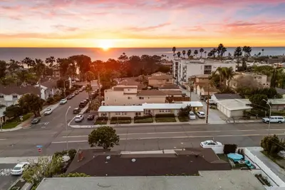 a sunset over a city with a parking lot at Tourmaline Beach Cottage North -Steps to Ocean, AC in San Diego