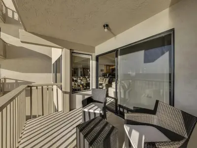 a balcony of a house with two chairs on it at Solana Oceanfront with Pool, Spa, Ocean Views in Solana Beach