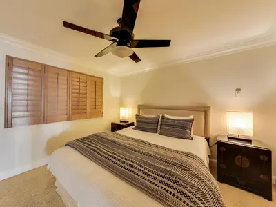a bedroom with a bed with a ceiling fan at Solana Oceanfront with Pool, Spa, Ocean Views in Solana Beach