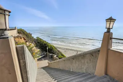 a stairway leading down to a beach with a light at Solana Oceanfront with Pool, Spa, Ocean Views in Solana Beach
