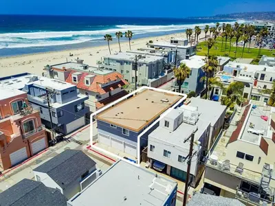 an aerial view of a beach with buildings and palm trees at South Shore Dream with Ocean View, Large Patio, BBQ in San Diego