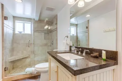 a bathroom with a sink and a toilet and a shower at South Shore Dream with Ocean View, Large Patio, BBQ in San Diego