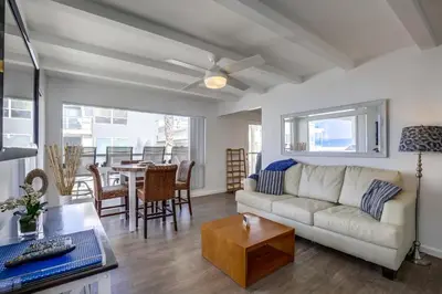 a living room with a couch and a table at South Shore Gem with Ocean View, Patio, BBQ in San Diego