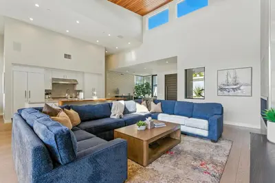 a living room with blue couches and a table at Luxury Stay with Pool, Spa, Fire Pit, Outdoor Lounge & Stunning Ocean Views, Encinitas Retreat in Encinitas
