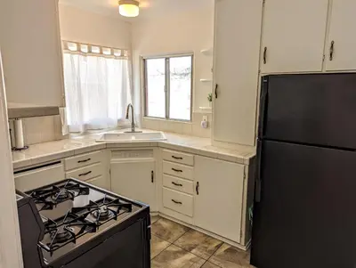 a kitchen with a stove and a refrigerator at Large 3 Bedroom near everything in San Diego in San Diego
