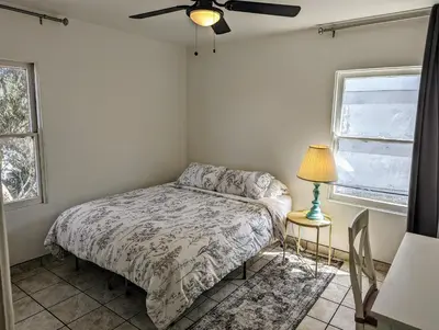 a bedroom with a bed and a ceiling fan at Large 3 Bedroom near everything in San Diego in San Diego