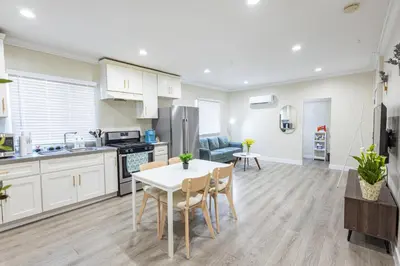 a kitchen and living room with a table and chairs at Modern Cozy Stylish Home AC WasherDryer Parking 3 minutes to Balboa Park in San Diego