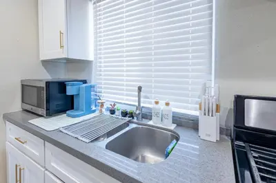 a kitchen counter with a sink and a microwave at Modern Cozy Stylish Home AC WasherDryer Parking 3 minutes to Balboa Park in San Diego