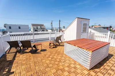 a patio with chairs and a table on a deck at Mission Casa Del Mar in San Diego