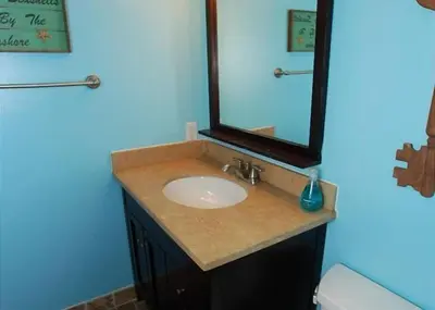 a bathroom with a sink and a mirror at Get Your Vitamin Sea! Steps to beach! Fire pit! in Newport Beach