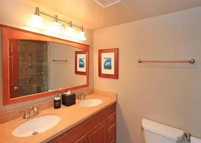 a bathroom with two sinks and a large mirror at Get Your Vitamin Sea! Steps to Sand, Bikes, & Balcony in Newport Beach