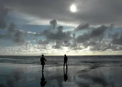 two people standing on the beach looking at the ocean at Get Your Vitamin Sea! Steps to Sand, Bikes, & Balcony in Newport Beach