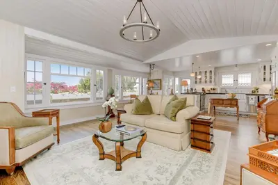 a living room with a couch and a table at Seahorse Cottage in Secret Garden Sanctuary in San Diego