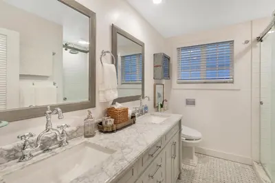 a bathroom with a sink and a toilet and a mirror at Seahorse Cottage in Secret Garden Sanctuary in San Diego