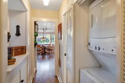 a hallway with a kitchen and a dining room at Seahorse Cottage in Secret Garden Sanctuary in San Diego