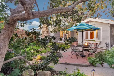 a patio with a table and an umbrella at Seahorse Cottage in Secret Garden Sanctuary in San Diego