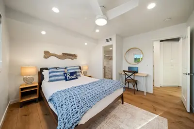 a bedroom with a bed and a desk in a room at Huge Beach Views Starfish Cottage Ocean Beach in San Diego