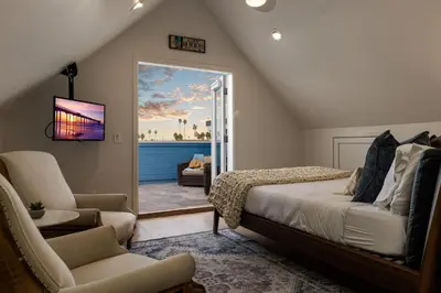 a bedroom with a bed and a sliding glass door at Huge Beach Views Starfish Cottage Ocean Beach in San Diego