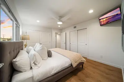 a bedroom with a bed and a ceiling fan at Stunning OB Ocean View Stay in San Diego