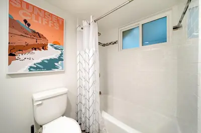 a bathroom with a toilet and a shower at Ocean Beach Cottage with Views in San Diego