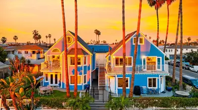 a house painted like a boat at sunset at OB Cottage Beach Views in San Diego