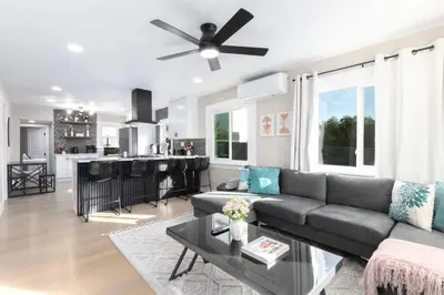 a living room with a couch and a kitchen at Modern Getaway Near Downtown – Family Friendly in San Diego