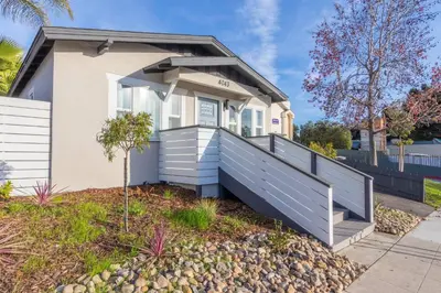 a house with a porch and a fence at Modern Getaway Near Downtown – Family Friendly in San Diego