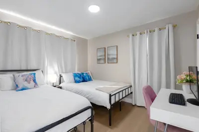 a small room with two beds and a desk at Modern Getaway Near Downtown – Family Friendly in San Diego